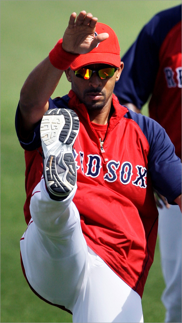 Boston Red Sox shortstop Julio Lugo kicks his right leg while working out prior to Friday's game against the New York Yankees in Fort Myers, Fla., Friday March 13, 2009. According to manager Terry Francona, Lugo later left during the first inning of the game with soreness in his knee