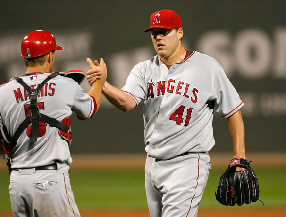 John Lackey of the Los Angeles Angels of Anaheim is congratulated by catcher Jeff Mathis after throwing a two-hiiter against the Boston Red Sox at Fenway Park on July 29, 2008 in Boston, Massachusetts.