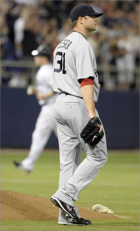 Red Sox pitcher Jon Lester walks near the mound as Minnesota Twins' Justin Morneau rounds third base after hitting a three-run home run during the fifth inning of a baseball game Tuesday, May 26, 2009, in Minneapolis.(