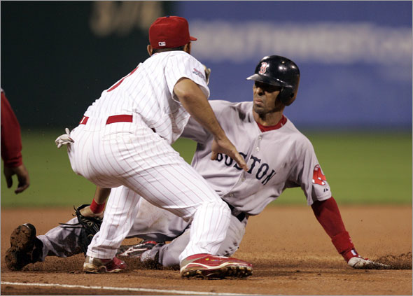 Philadelphia Phillies third baseman Pedro Feliz puts the tag on Boston Red Sox' Julio Lugo who advanced from second on a base hit by Daisuke Matsuzaka in the third inning of an interleague baseball game Saturday, June 13, 2009, in Philadelphia. 
