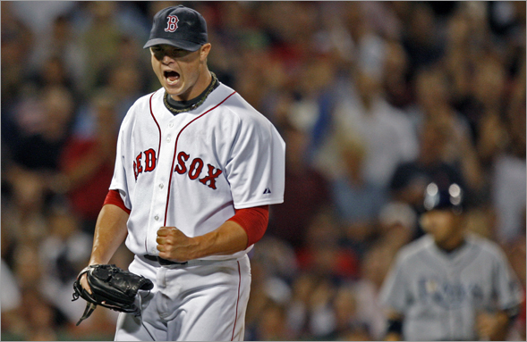 Red Sox pitcher Jon Lester reacts after striking out the Rays Rocco Baldelli to end the top of the sixth inning, and strand two Tampa Bay runners on base. 