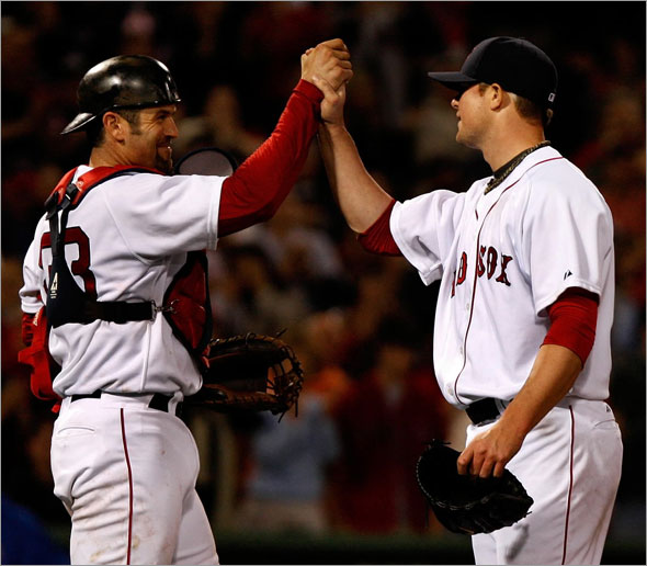 Boston Red Sox catcher Jason Varitek (33) congratulates Boston Red Sox starting pitcher Jon Lester (31) after his 2 hit 1 run complete game against the Texas Rangers.