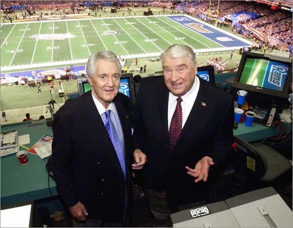 Fox broadcasters Pat Summerall, left, and John Madden stand in the FOX broadcast booth at the Louisiana Superdome before Super Bowl XXXVI Sunday, Feb. 3, 2002, in New Orleans. 
