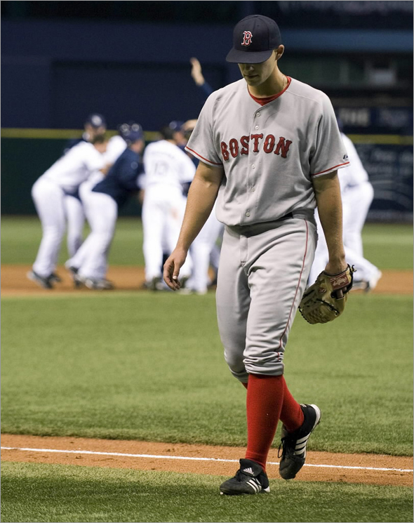 Red Sox reliever Justin Masterson walks off the field after giving up the game winning RBI single to Tampa Bay Rays' Dioner Navarro during the ninth inning of their American League baseball game in St. Petersburg, Florida September 16, 2008.