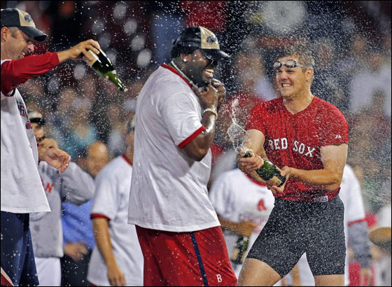 Tim Wakefield, David Ortiz and Jonathan Papelbon celebrate on the field. The Red Sox clinched the 2007 American League East Championship with a victory over the Minnesota Twins, combined with the Yankees loss to the Devil Rays in Tampa.