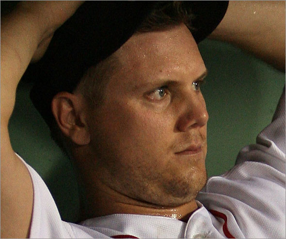 Jonathan Papelbon of the Boston Red Sox sits in the dugout after an error in the ninth inning against the Oakland Athletics at Fenway Park July 28, 2009 in Boston, Massachusetts.