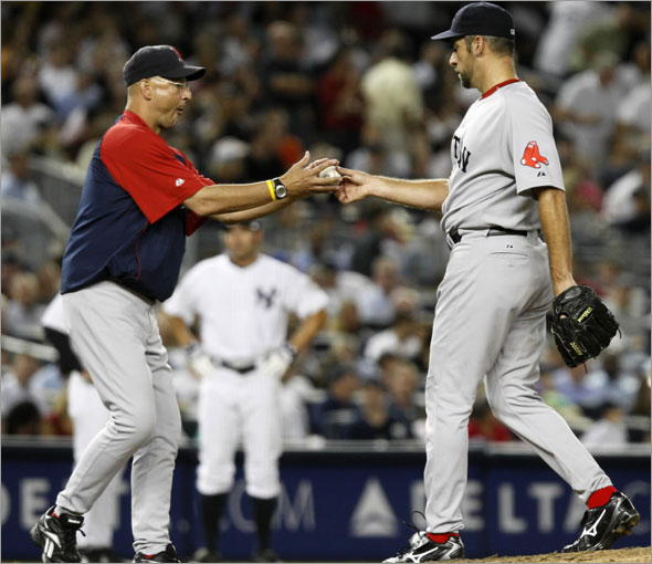 Boston Red Sox manager Terry Francona, left, takes the ball from pitcher John Smoltz after Smoltz gave up a three-run home run to New York Yankees' Melky Cabrera in a baseball game at Yankee Stadium in New York, Thursday, Aug. 6, 2009.