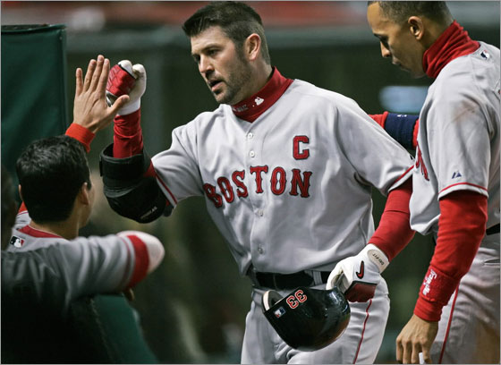 Jason Varitek is congratulated at the dugout after his solo home run off Cleveland Indians relief pitcher Jensen Lewis in the ninth inning of a baseball game Tuesday, April 15, 2008, in Cleveland. At right is Julio Lugo. Varitek's homer broke a 3-3 tie and Boston went on to win 5-3.
