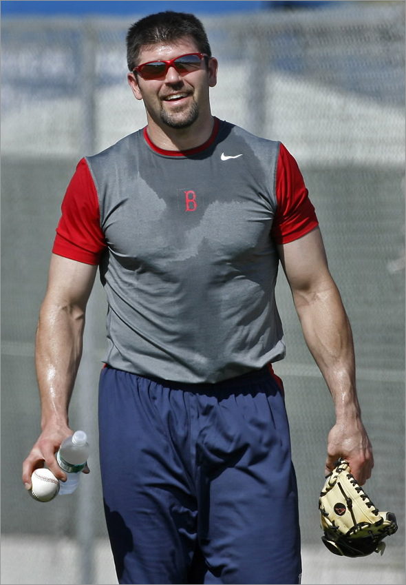 Red Sox captain Jason Varitek arrived in camp today, just in time to take part in the team's conditioning drills that they put players through at the beginning of the season. He is shown leaving the field after the drills, drenched in sweat.
