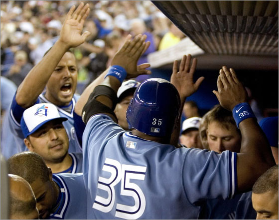 Frank Thomas is congratulated in the dugout by teammates after he doubled in two runs in the seventh inning of their MLB baseball game against the Boston Red Sox in Toronto April 4, 2008.