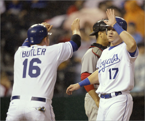 Mike Jacobs (17) and Billy Butler (16) celebrate after scoring on a double by Alberto Callaspo during the sixth inning of a baseball game against the Boston Red Sox on Monday