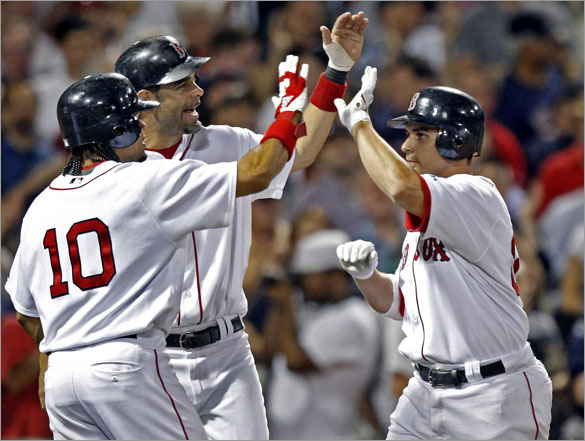 Red Sox catcher Kevin Cash is welcomed back to the dugout following his bottom of the eighth inning three run home run by teammates Coco Crisp and Mike Lowell. 