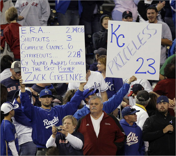 Fans hold up signs praising Kansas City Royals starting pitcher Zack Greinke after the Royals beat the Boston Red Sox 5-1 in a baseball game Tuesday, Sept. 22, 2009