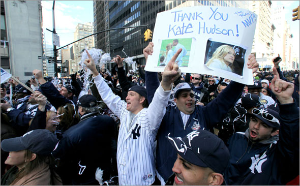 Chris Sessa holds a sign with a picture New York Yankees' Alex Rodriquez and Kate Hudson during a ticker-tape parade along Broadway celebrating their 27th World Series championship on Friday, Nov. 6, 2009, in New York.