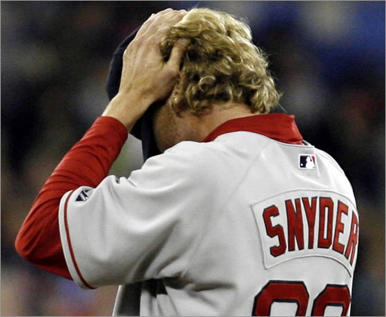 Boston Red Sox reliever Kyle Snyder rubs his head while waiting to be relieved during the sixth inning of their baseball game against the Toronto Blue Jays in Toronto on Saturday, April 5, 2008. The Jays scored six runs in the inning, going on to defeated the Sox 10-2. 