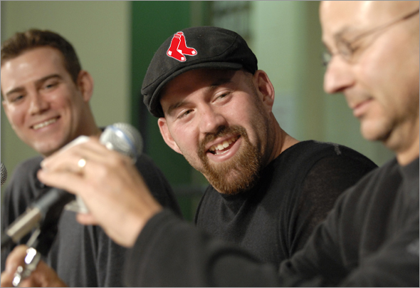 Kevin Youkilis responds to a question during a Red Sox press conference announcing an agreement to terms on a 4 year contract with the first baseman. Red Sox manager Terry Francona is seen at far right.