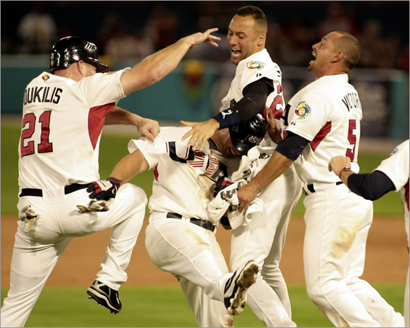 Team USA's David Wright is congratulated by Kevin Youkilis, Derek Jeter, second from right, and Shane Victorino after a 6-5 win over Puerto Rico at the World Classic Baseball game in Miami, Tuesday, March 17, 2009. 