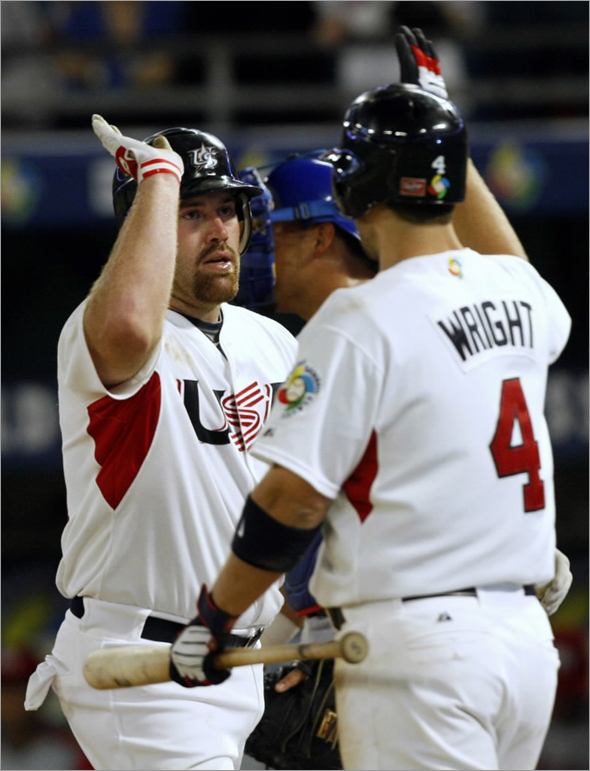 Team USA's Kevin Youkilis is congratulated by teammate David Wright after he hit a third inning home run against Team Puerto Rico during their second round World Baseball Classic game in Miami, Florida, March 17, 2009.