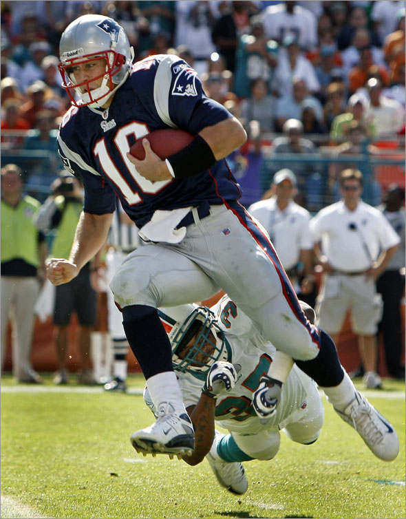 Patriots quarterback Matt Cassel leaps into the end zone on a second quarter touchdown run, beating the Dolphins safety Yerimiah Bell  (37) in the process, and putting New England ahead 10-7