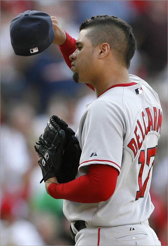 Red Sox pitcher Manny Delcarmen wipes his head after giving up a double to Los Angeles Angels' Casey Kotchman allowing Howie Kendrick and Chone Figgins to score during the eighth inning of their MLB American League baseball game in Anaheim