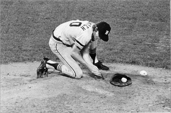 6/24/1976 Fenway Park, during a Red Sox vs Detroit Tigers. Mark Fidrych of Detroit Tigers digs a small hole so he will have good footing while pitching.