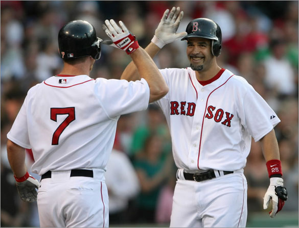 Mike Lowell of the Boston Red Sox celebrates his grand slam with teammate J.D. Drew #7 at Fenway Park June 12, 2008 in Boston, Massachusetts. 