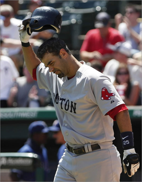 Boston Red Sox Mike Lowell throws his batting helmet after striking out against the Texas Rangers during the fifth inning of their game in Arlington, Texas August 16, 2009.