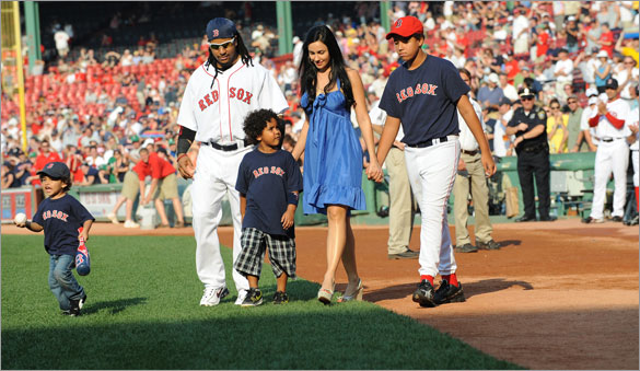 Red Sox left fielder Manny Ramirez walks with his family including sons Lucas, Manny Jr. and Manuel and his wife Juliana prior to his being honored for hitting 500 career home runs.