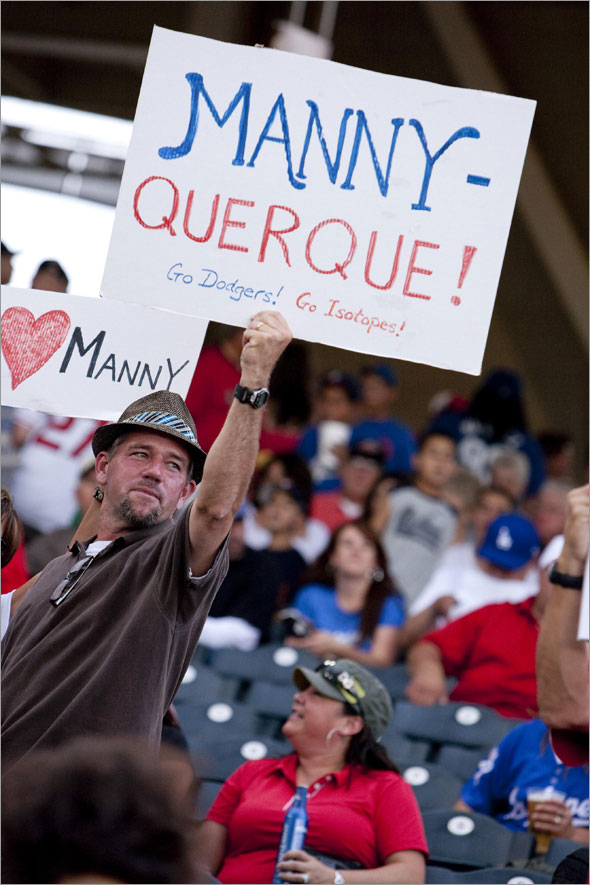 Jeff Turcotte, of Albuquerque, N.M., holds up a greeting for Los Angeles Dodgers' Manny Ramirez while Ramirez was playing for the Dodgers' Triple-A baseball team, the Albuquerque Isotopes, against the Nashville Sounds in Albuquerque