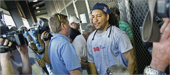 Manny Ramirez is surrounded as he stands up to leave after holding an impromptu question and answer session with the media outside the covered batting cages after he had taken some cuts inside.