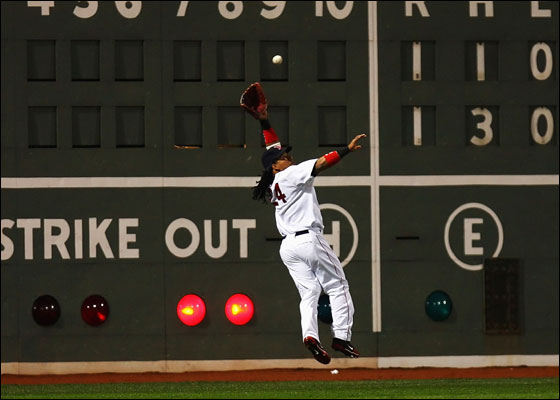 Manny Ramirez of the Boston Red Sox catches a ball hit by Kenny Lofton of the Cleveland Indians during Game One of the American League Championship Series at Fenway Park 12 October 2007 in Boston, Massachusetts. 