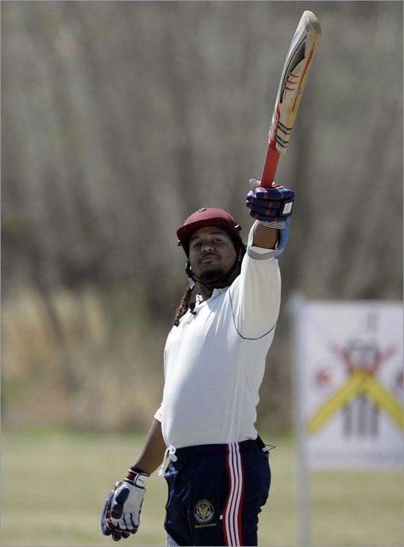 Manny Ramirez jokingly raises a cricket bat prior to attempting to hit a ball,  Wednesday, March 18, 2009, at the Arizona Cricket Club's pitch in Gilbert, Ariz.