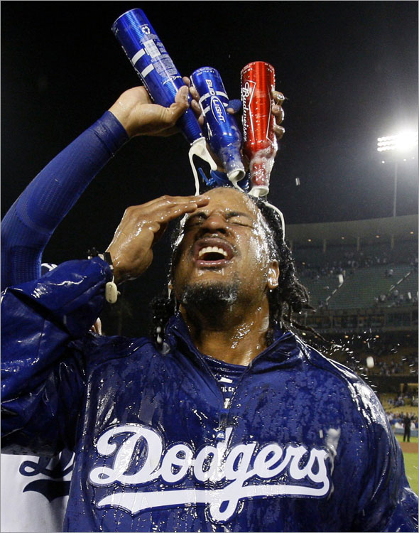 Manny Ramirez celebrates with teammates after they clinched the National League West following their game against the San Diego Padres in Los Angeles, September 25, 2008.