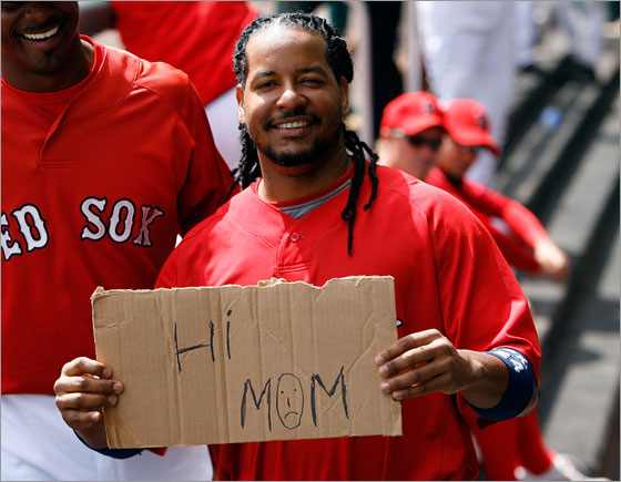Outfielder Manny Ramirez of the Boston Red Sox holds a sign during the delay of the Grapefruit League Spring Training game against the Toronto Blue Jays on March 19, 2008 at City of Palms Park in Ft. Myers, Florida. The Red Sox players unanimously voted to not play their last Spring Training game in Florida and not get on the plane to Japan in a dispute over whether coaches and staff are paid a $40,000 stipend for the trip to Japan.