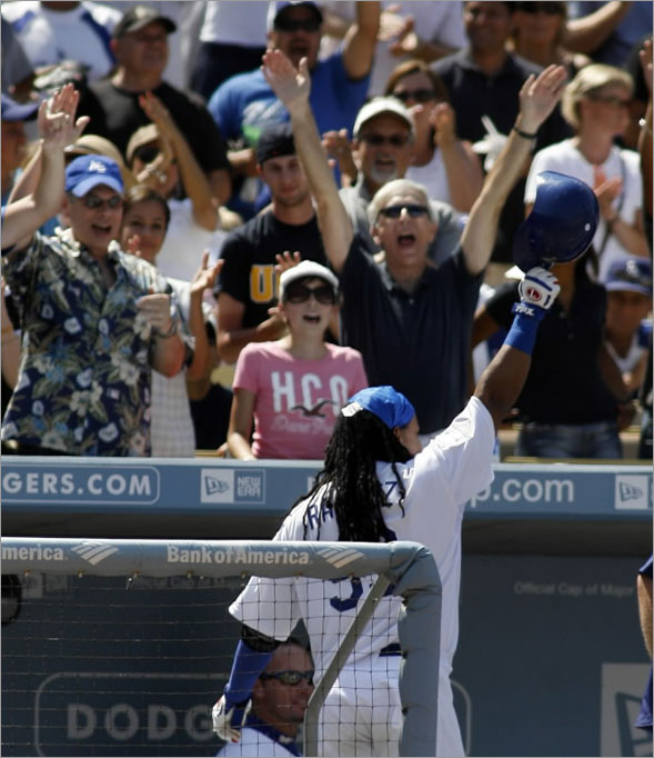 Manny Ramirez tips his batting helmet to the crowd as they cheer his solo home run in the fifth inning during an MLB baseball game against the Arizona Diamondbacks, Sunday, Aug. 3, 2008 in Los Angeles.