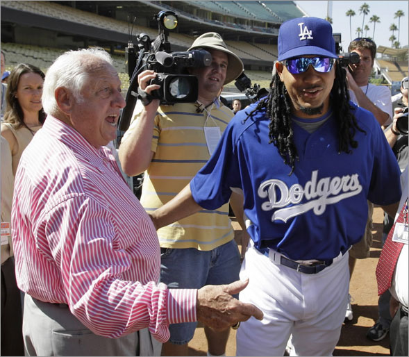Former Los Angeles Dodgers manager Tommy Lasorda greets the teams newest player, Manny Ramirez on his way to a news conference before the Dodgers baseball game against the Arizona Diamondbacks in Los Angeles, Friday, Aug. 1, 2008.