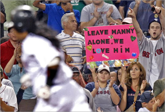 07/28/08: As Red Sox LF Manny Ramirez rounds third base following his bottom of the ninth inning solo home run, a fan holds a sign reading 