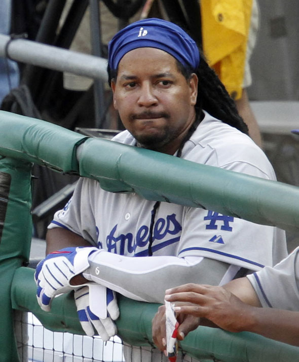 Manny  Ramirez watches the final out of the ninth inning from the dugout during a baseball game against the Pittsburgh Pirates in Pittsburgh, Monday, April 5, 2010.
