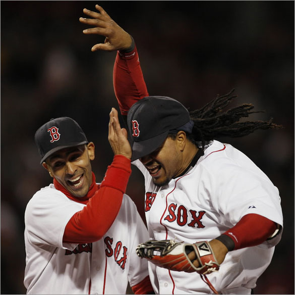 Manny Ramirez, right, is congratulated by teammate Julio Lugo after Ramirez threw out Tampa Bay Rays' Carlos Pena at home plate during the fourth inning of a baseball game at Fenway Park in Boston, Saturday, May 3, 2008.