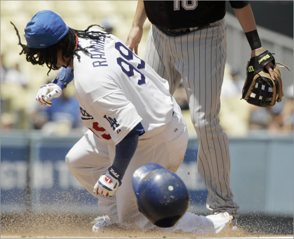 Dodgers' Manny Ramirez steals second base as Colorado Rockies second baseman Jeff Baker (10), looks on in the fourth inning of a National League baseball game in Los Angeles on Thursday, Aug. 21, 2008. It was Ramirez' first stolen base as a Dodger 