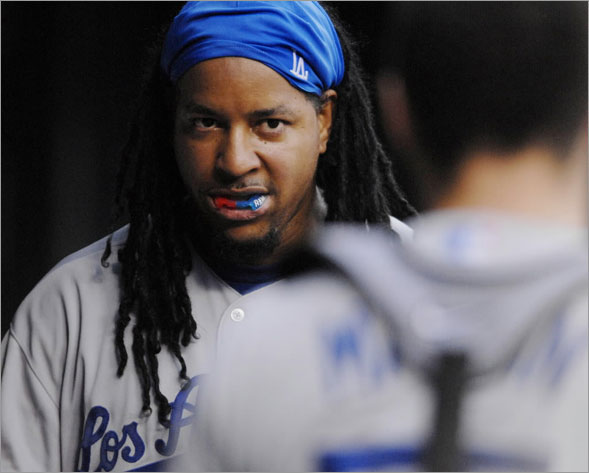 Los Angeles Dodgers' Manny Ramirez looks towards catcher Russell Martin as Ramirez is congratulated after hitting his second-inning inning solo home run during their baseball game against the St. Louis Cardinals on Wednesday, Aug. 6, 2008, in St. Louis.