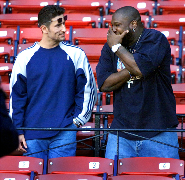 9-26-2001: Former Red Sox first baseman Mo Vaughn (right) was a visitor at Fenway Park during Boston's batting practice. He got together in the stands and had a few laughs with ex-teammate Nomar Garciaparra.