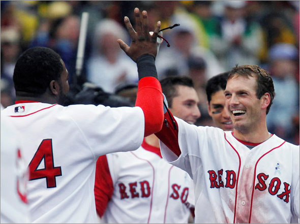 Boston Red Sox's Nick Green, right, celebrates his walk-off home run in the ninth inning of a baseball game with David Ortiz, left, Sunday, June 21, 2009, in Boston. The Red Sox won 6-5.