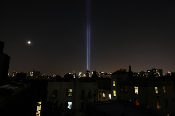 The Tribute in Light is seen during a test run as the moon rises over the East Village with Lower Manhattan in the background September 8, 2008 in New York City.