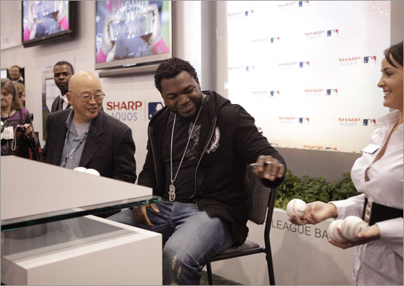 David Ortiz, center, signs autographs at the Sharp booth at the International Consumer Electronics Show (CES) in Las Vegas,Thursday, Jan. 8, 2009.