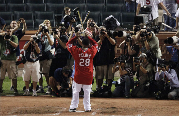National League's Prince Fielder of the Milwaukee Brewers holds up his championship trophy after winning the MLB baseball Home Run Derby in St. Louis, Monday, July 13, 2009.