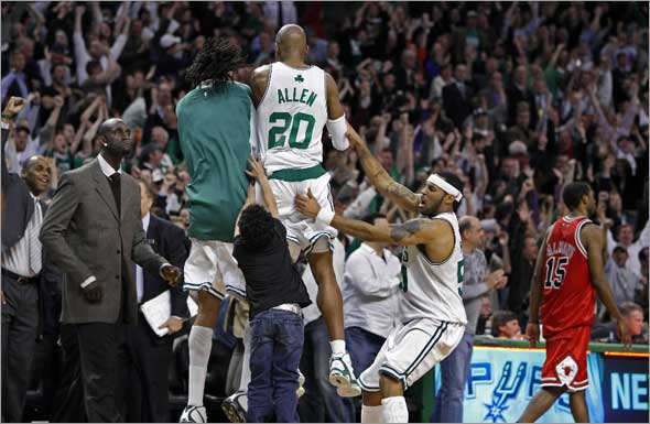 The Celtics Ray Allen won the game with a three pointer in the final seconds of the game, 118-115. Here he is mobbed by his teammates, Kevin Garnett is at left, the Bulls John Salmons walks off the court at right fter the final buzzer sounded.