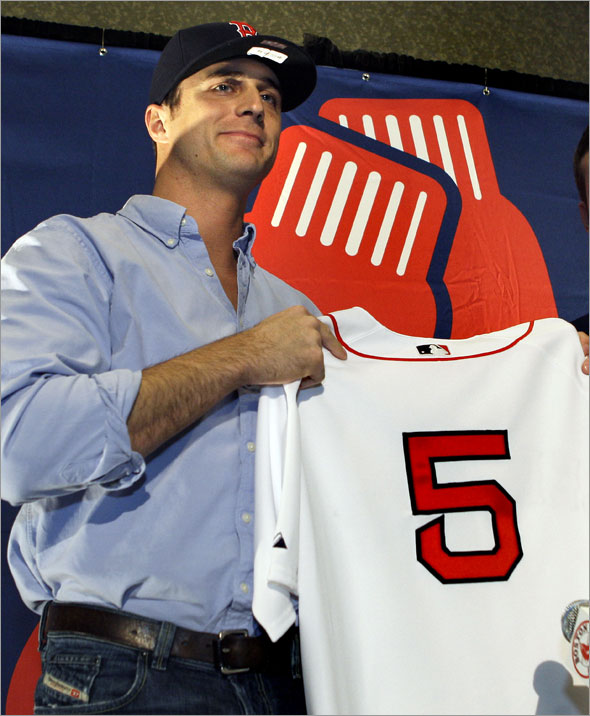 Newly acquired Boston Red Sox Rocco Baldelli holds up his new number 5 Red Sox jersey during a news conference in Boston on Thursday, Jan. 8, 2009. 