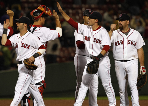 The Boston Red Sox celebrate taking Game 1 of the four game series with a 7-0 win over the Toronto Blue Jays . 