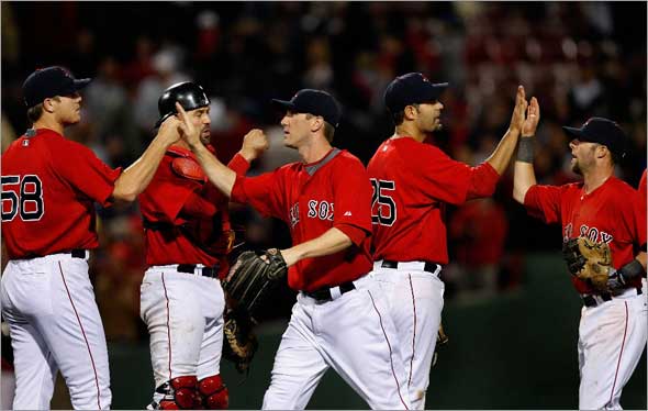 The Boston Red Sox celebrate a much needed win and a great comeback against the Orioles in Game 1 of the series after a bad beginning by Boston Red Sox starting pitcher Brad Penny, not pictured.